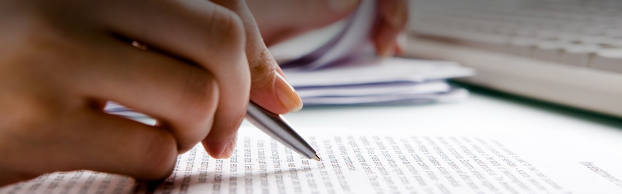 hands-holding-pen-while-reading-banner-horizontal-1440x450-image-file