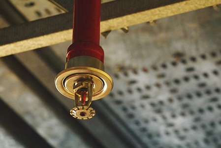 An automatic fire sprinkler in a red water pipe system.