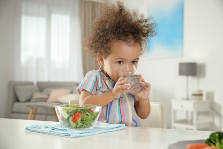 young-girl-drinking-water-from-glass-indoor-horizontal-image-file-1324457708