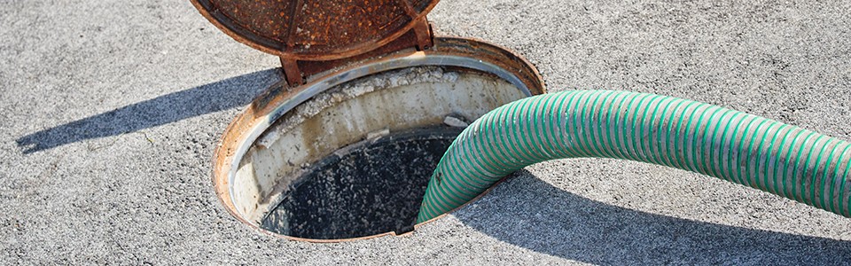Sewer being pumped with green hose 