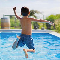boy jumping in pool