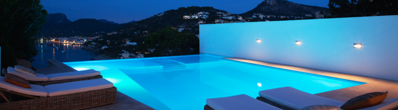 Lit up pool at night overlooking the mountains